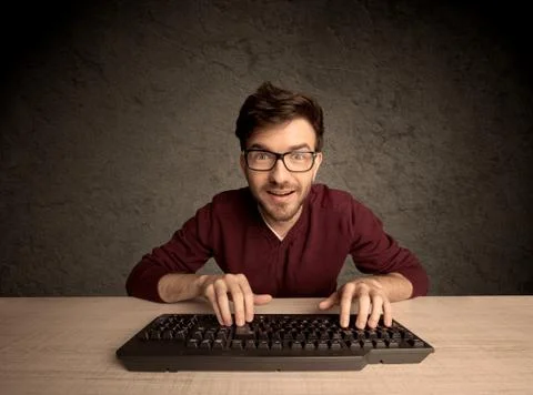 Computer geek typing on keyboard 스톡 사진