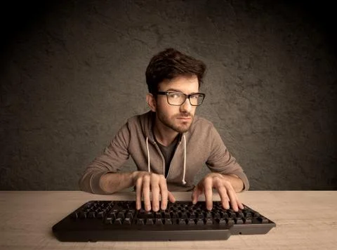 Computer geek typing on keyboard Stockfoto's