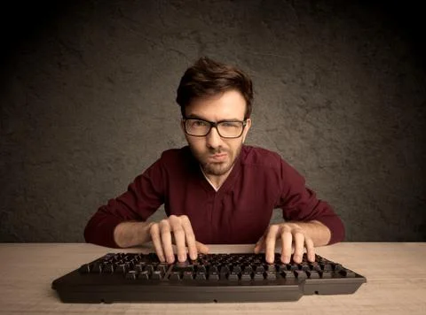 Computer geek typing on keyboard 스톡 사진