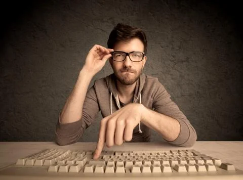 Computer geek typing on keyboard 스톡 사진