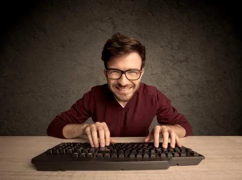 Computer geek typing on keyboard 스톡 사진