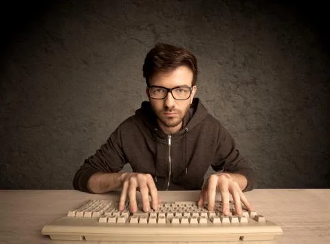 Computer geek typing on keyboard 스톡 사진