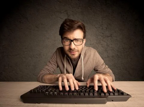 Computer geek typing on keyboard 스톡 사진