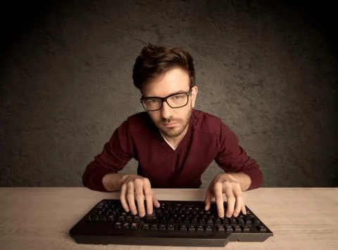 Computer geek typing on keyboard 스톡 사진
