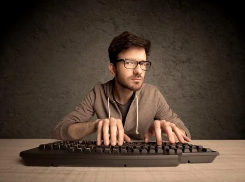 Computer geek typing on keyboard Foto stock