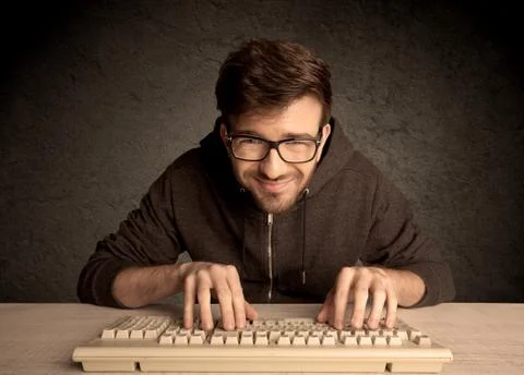 Computer geek typing on keyboard 스톡 사진