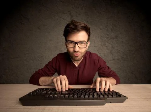 Computer geek typing on keyboard 스톡 사진