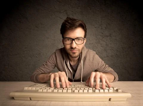 Computer geek typing on keyboard 스톡 사진