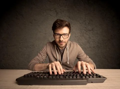 Computer geek typing on keyboard 스톡 사진
