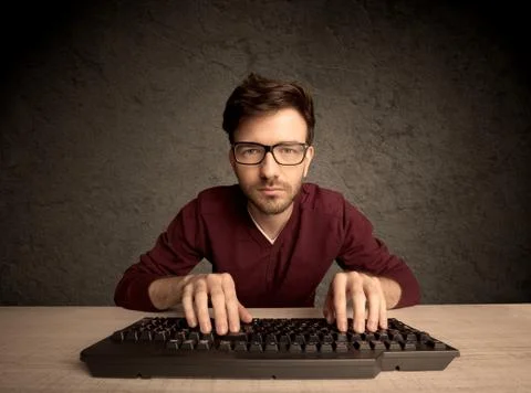 Computer geek typing on keyboard 스톡 사진