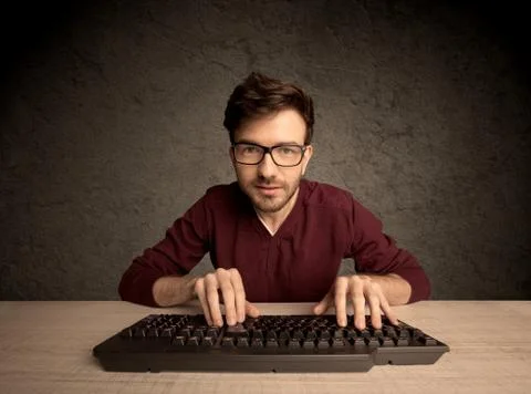 Computer geek typing on keyboard 스톡 사진