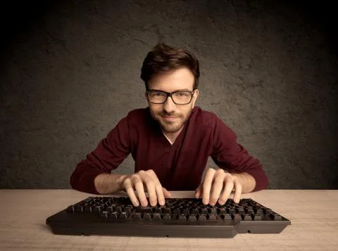 Computer geek typing on keyboard 스톡 사진