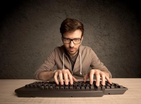 Computer geek typing on keyboard 스톡 사진