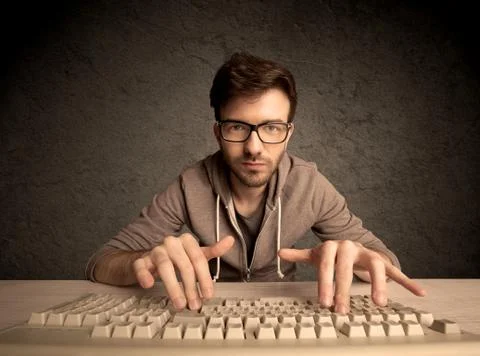 Computer geek typing on keyboard 스톡 사진