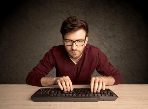 Computer geek typing on keyboard 스톡 사진