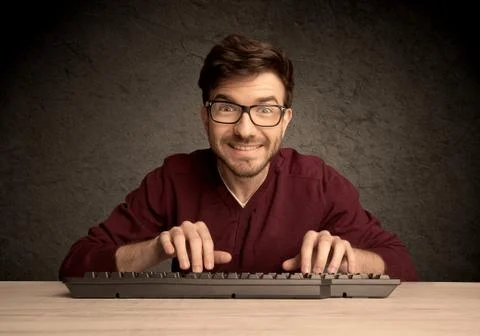Computer geek typing on keyboard Stockfoto's