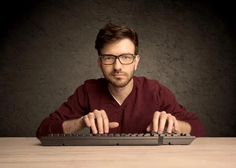 Computer geek typing on keyboard Stockfoto's