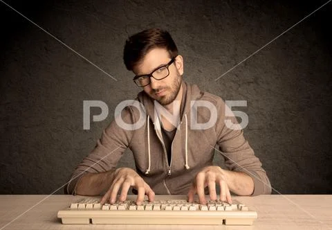 Computer geek typing on keyboard Stock Photos