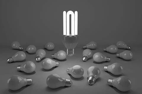 Computer generated image of lit energy efficient lightbulb over bulbs Foto stock