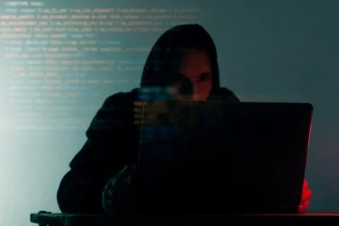 Computer genius behind laptop breaks the law, corrupted program code Foto stock