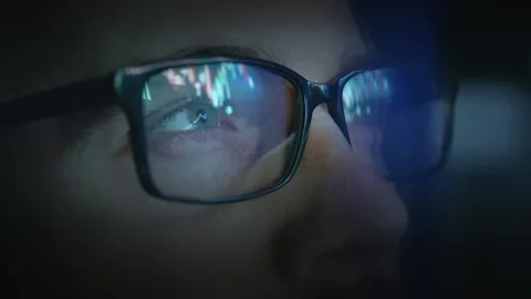 Computer Glasses Reflecting Stock Market Data Dark Room Blue Light Technology Stock Footage 297322396