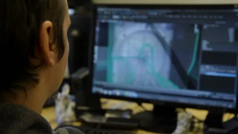 Computer graphics artist working on graphic model on computer Stock Footage 238003557