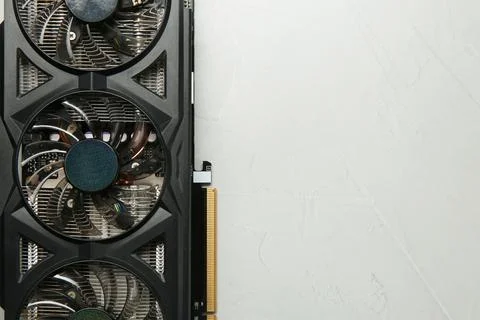 Computer graphics card on gray textured background, top view. Space for text Foto stock