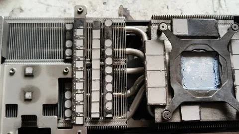 Computer graphics card interior with heatsink fins and thermal pads closeup Stock Footage 348708995