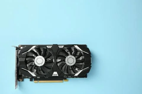 Computer graphics card on light blue background, top view. Space for text Foto stock