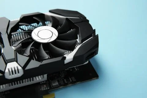 Computer graphics card on light blue background, closeup. Space for text Foto stock