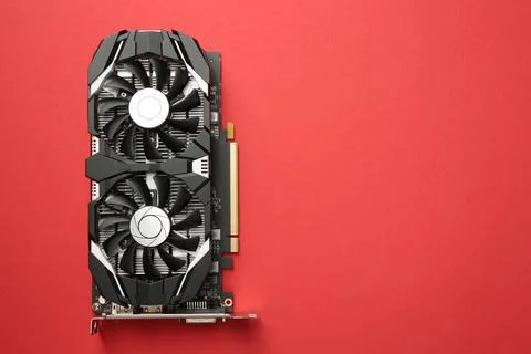 Computer graphics card on red background, top view. Space for text Foto stock
