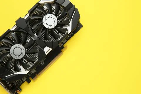 Computer graphics card on yellow background, top view. Space for text 스톡 사진