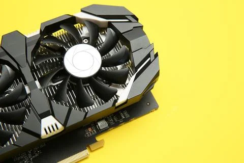 Computer graphics card on yellow background, above view. Space for text Stock Photos