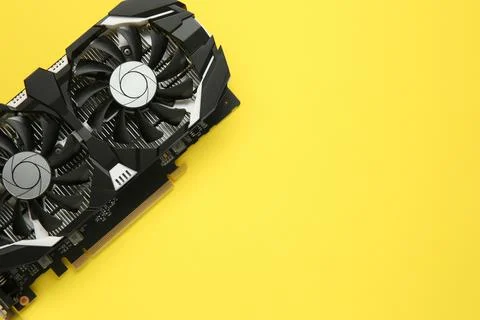 Computer graphics card on yellow background, top view. Space for text Stock Photos