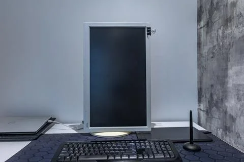 A computer graphics desk, a wireless mouse and a pen for drawing on the des.. Stock Photos