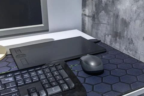 A computer graphics desk, a wireless mouse and a pen for drawing on the des.. Stock Photos