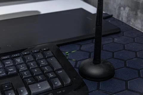 A computer graphics desk, a wireless mouse and a pen for drawing on the des.. Stock Photos