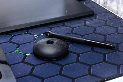A computer graphics desk, a wireless mouse and a pen for drawing on the des.. Stock Photos
