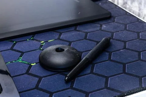 A computer graphics desk, a wireless mouse and a pen for drawing on the des.. Stock Photos