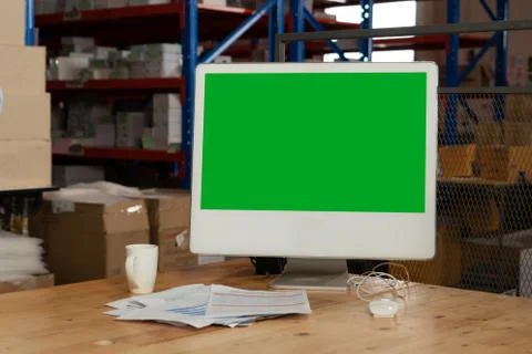 Computer with green screen display in warehouse storage room Stock Photos