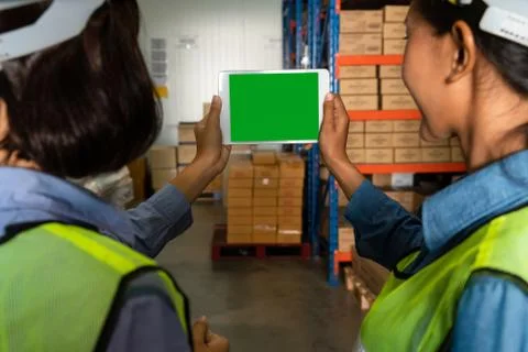 Computer with green screen display in warehouse storage room Stock Photos