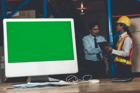Computer with green screen display in warehouse storage room Stock Photos