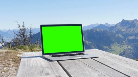 Computer with green screen on Top of Mountain in Switzerland 動画素材 88283133