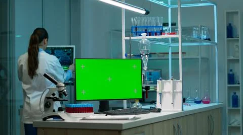 Computer with green screen working in labooratory with mock up monitor Stock Photos