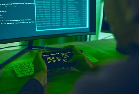 Computer hacker, coding and a man with phone for phishing, scam or cybersecurity Stock Photos