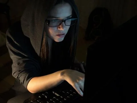 Computer hacker girl stealing information with laptop Stock-Fotos