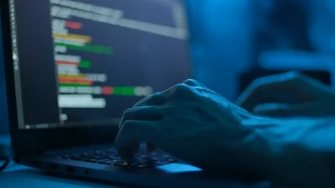 Computer hacker hacking secured computer system. Hands typing on pc desktop Stock Footage 117629954
