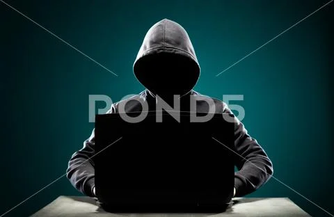 Computer hacker in hoodie. Obscured dark face. Data thief, internet fraud Stock Photos