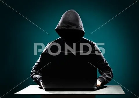 Computer hacker in hoodie. Obscured dark face. Data thief, internet fraud Stock Photos