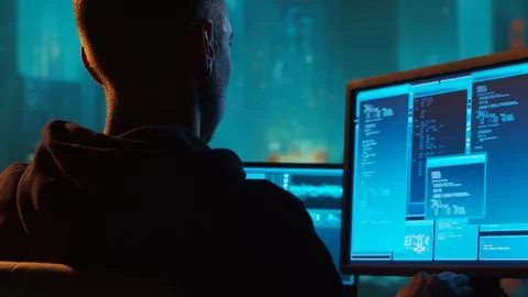 Computer Hacker in Hoodie. Obscured Dark Face. Concept of Hacker Attack, Virus Stockfoto's